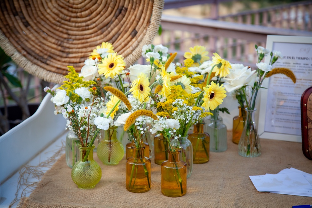 Yellow and white flowers decorating a wedding table