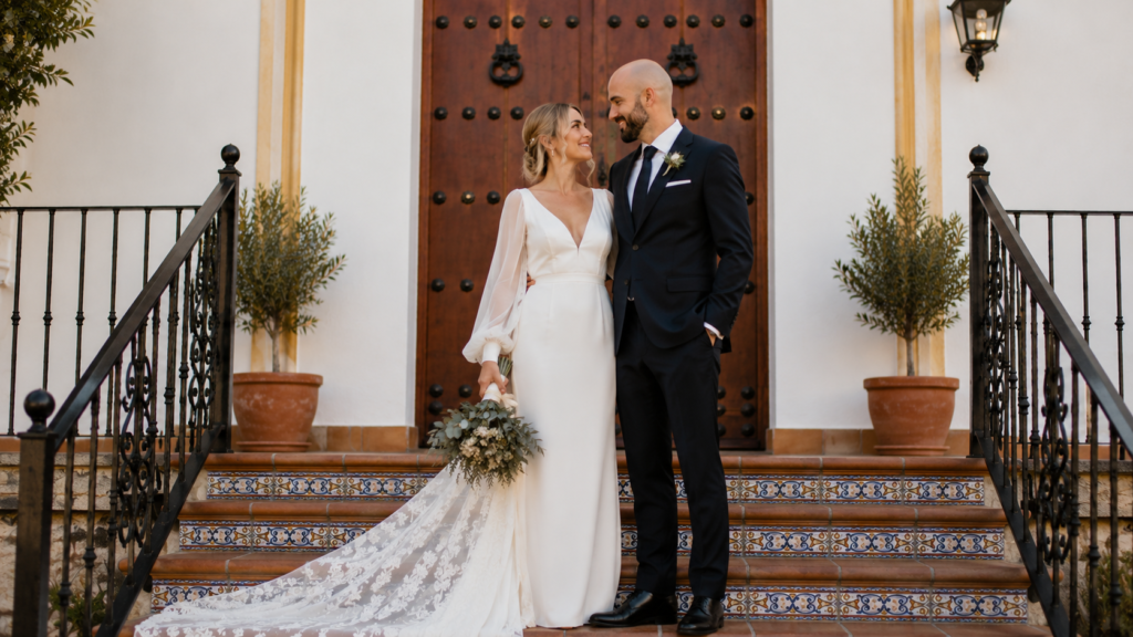 Couple posing in front of stairs in Spain