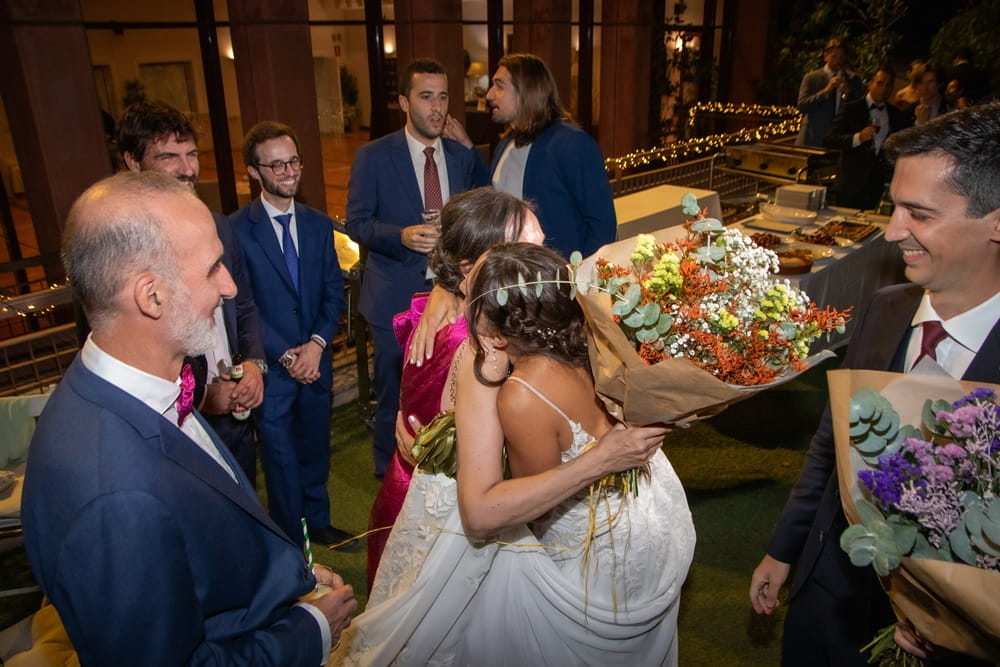 Bride giving flower bouquet to mother at Spanish wedding