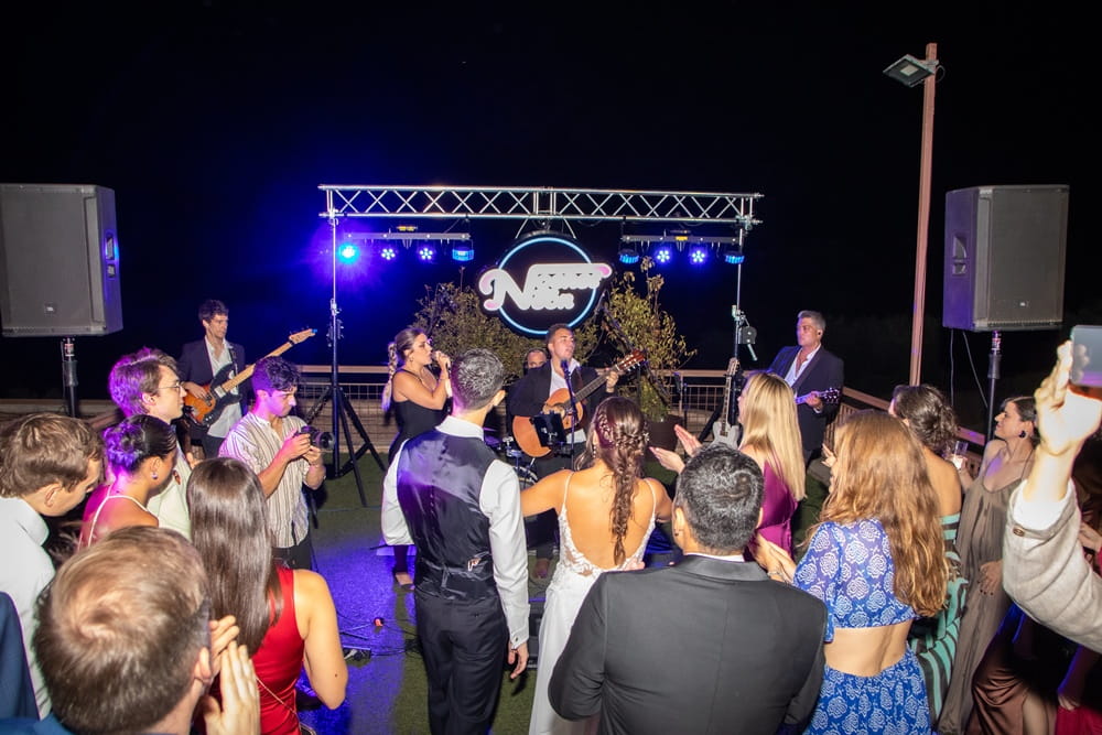 Live band playing at Spanish wedding with guests dancing around