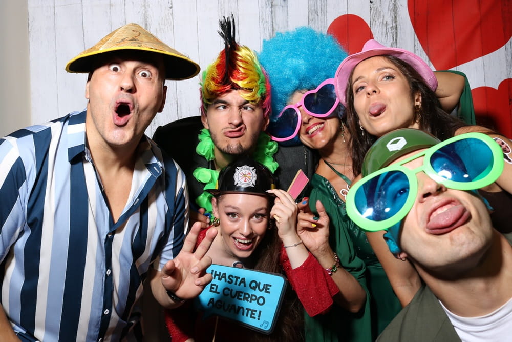 Guests posing with accessories at photo booth at Spanish wedding